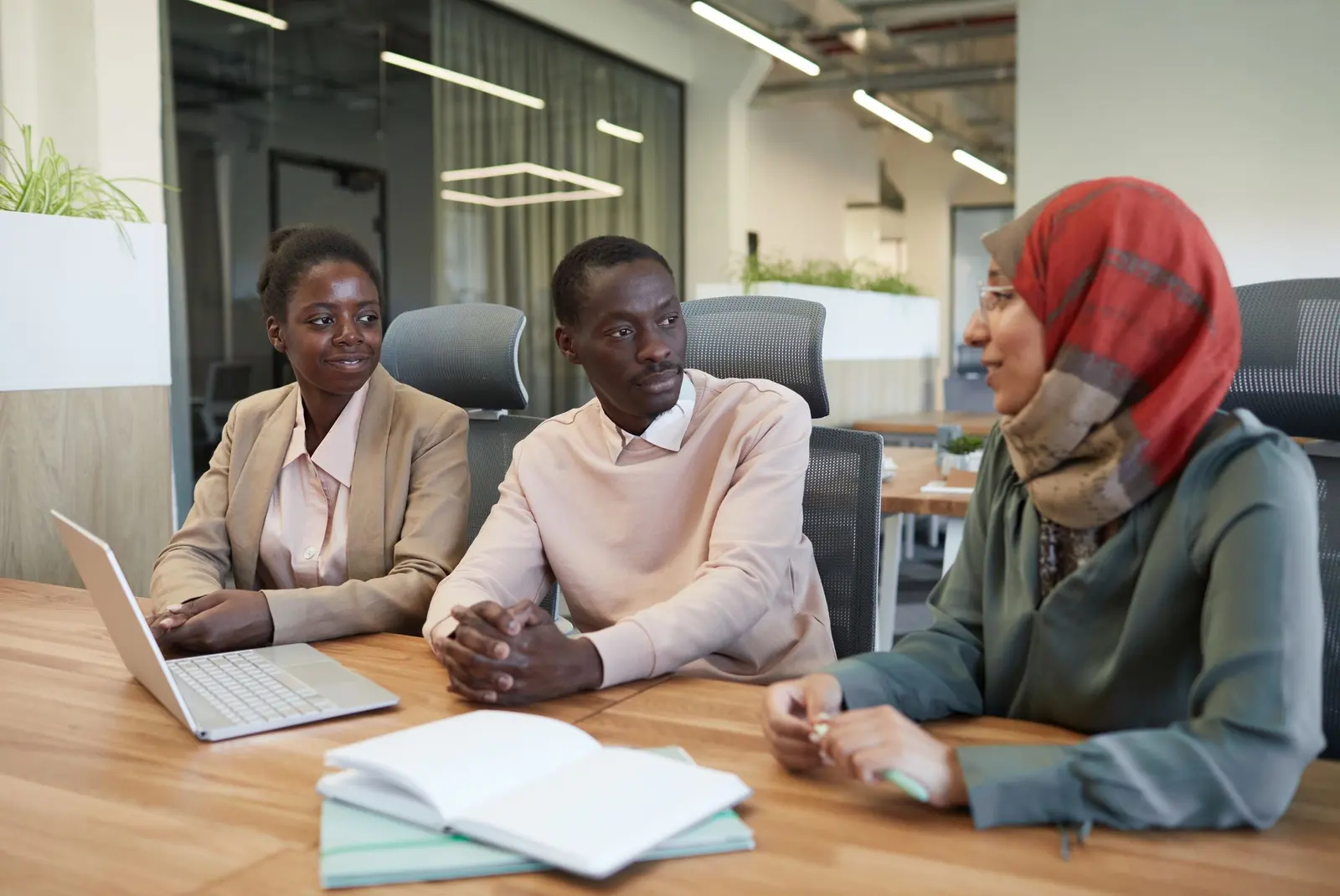 Kenyan colleagues discussing a project in a bright office