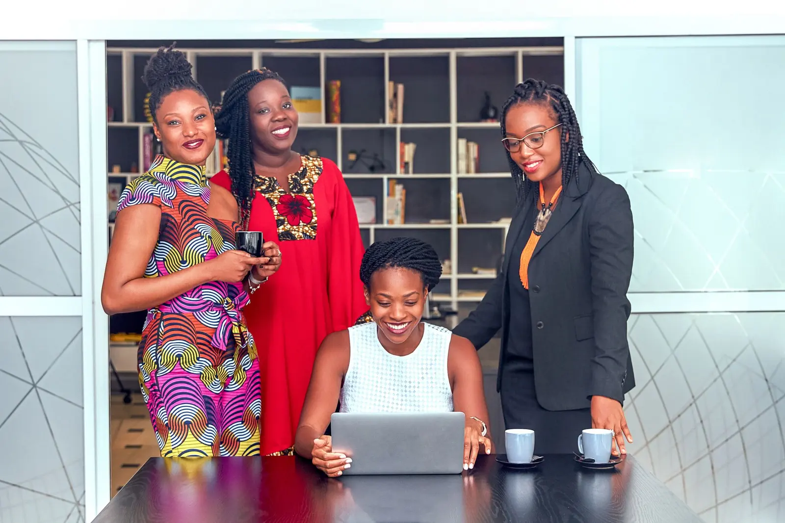 Women-led Nairobi business team gathered around a laptop